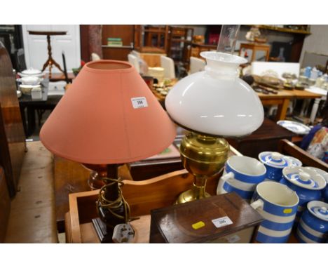 A brass oil lamp and a table lamp and shade 