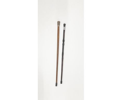 An African carved hardwood walking stick together with an Indian white metal topped walking stick.