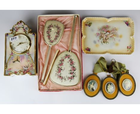 A porcelain clock together with a group of other items.