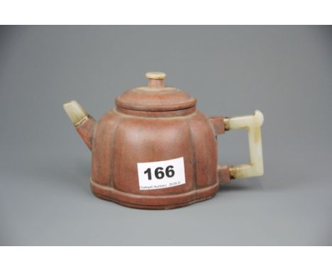 A Chinese Yixing terracotta teapot with jade handles and spout, spout to handle 17cm. H.10cm.