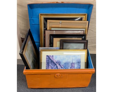 A metal travelling trunk with a quantity of framed pictures.