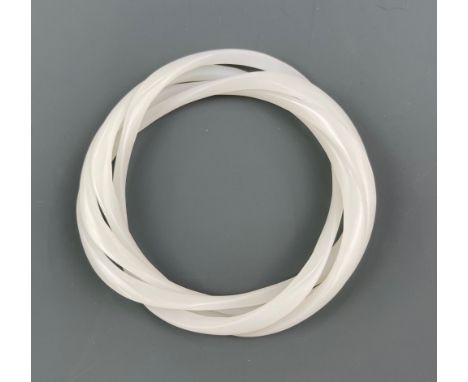 A rare Chinese carved white jade interlocking triple bangle.