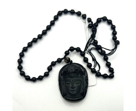 A silver coloured metal bangle, and a&nbsp;carved obsidian pendant, on a bead chain (2) 65mm inner diameter, hallmarked, but 