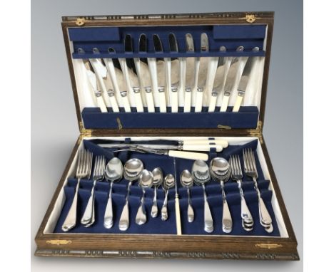 An oak canteen of stainless steel cutlery.