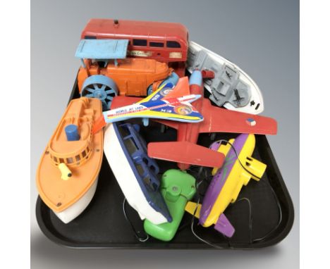 A group of plastic scale model boats, double decker bus, etc.