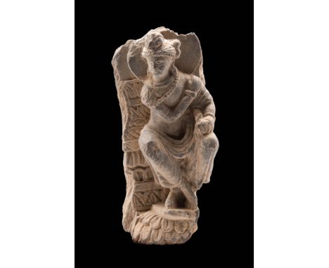 Ca. AD 200.A Gandharan schist stone seated bodhisattva. This intricately carved panel showcases a bodhisattva in a seated pos