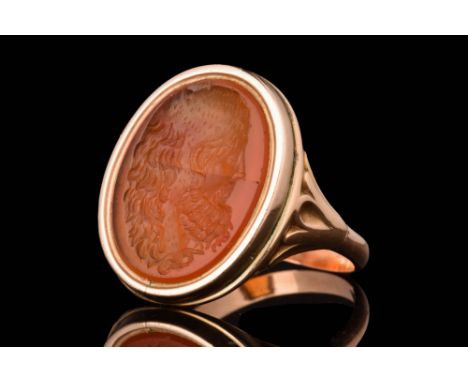 Ca. AD 1800 - 1900.A gold finger ring composed of a thin hoop with flaring shoulders supporting an oval-shaped frame set with