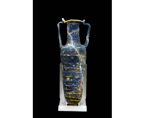 Ca. 200 - 100 BC.A Hellenistic core-formed glass amphoriskos, with dark blue and yellow trails in a banded pattern.Size: 130m