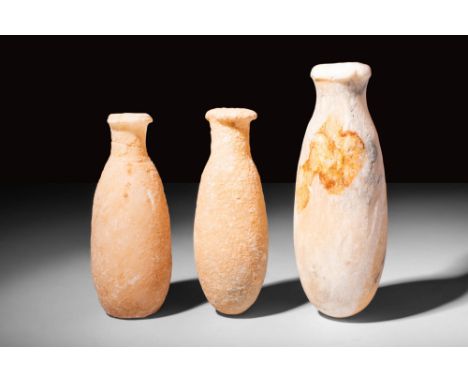 New Kingdom, 18th Dynasty Ca. 1550/1549 - 1292 BC.A collection of three Egyptian alabaster vessels with elongated bodies that