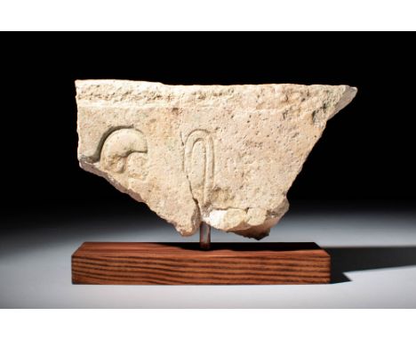 Late Period, Ca. 664 - 332 BC.An Egyptian sunk relief shows a man figure facing right and looking at a plant. The wig of the 
