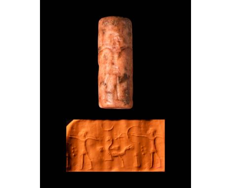Ca. 1100 - 900 BC.A stone cylinder seal from West Persia depicting a hunting scene with a god using a bow against wild animal