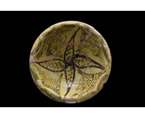 Persia or Bamayan, Ca. 9th - 11th century AD.A pottery bowl rising from a wide ring foot. The inside of the basin is embellis