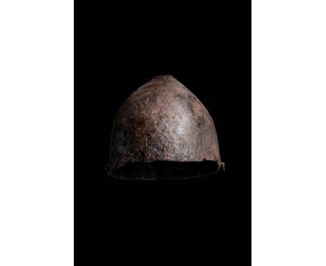 Ca. AD 900 - 1100.A Spangenhelm-type helmet comprised of four pieces of iron, riveted to form a slightly pointed bowl shape. 