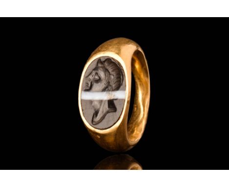 Republican, Ca. 100 BC - AD 100.A gold finger ring with expanding shoulders and a large oval bezel. This is set with a white-