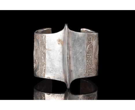 Ca. AD 1100 - 1300.An open-type bracelet featuring a prominent central ridge and reinforced edges, giving it a bold and strik