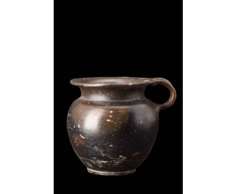 Ca. 450 BC.A black glazed cup with a well-proportioned, bulbous body, gradually tapers to a base, while the short neck flares