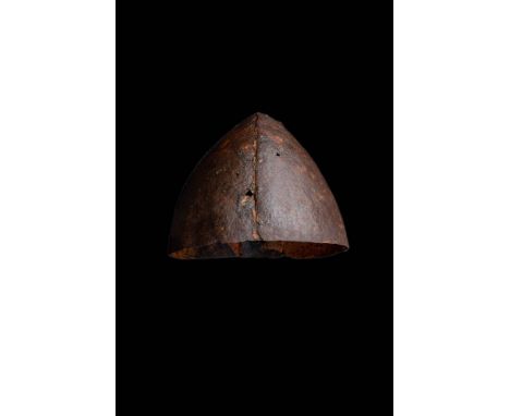 Ca. AD 900 - 1099.A Spangenhelm-type helmet comprised of four pieces of iron, riveted to form a slightly pointed bowl shape. 