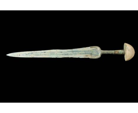 Western Asiatic/Aegan, Ca. 1200-700 BC.A bronze sword consists of an elongated triangular blade that tapers gracefully to a s
