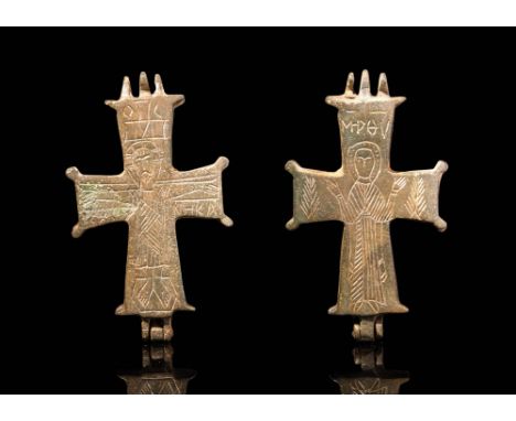Ca. AD 900 - 1200.A Byzantine bronze enclopion composed of two halves. On the front side, the encolpion bears an engraved cru
