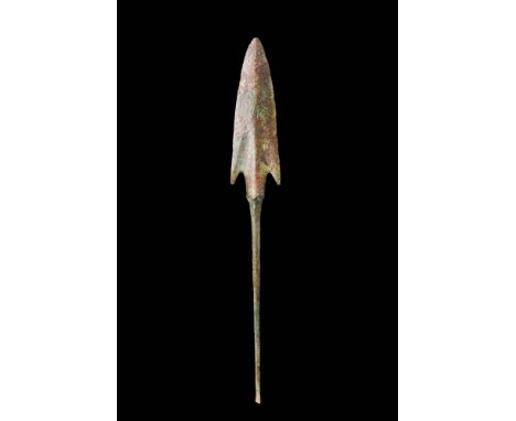 Western Asiatic/Aegan, Ca. 1200 - 700 BC.A bronze spearhead with a triangular-shaped blade is accentuated by a prominent midr