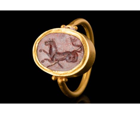 Ca. 100 BC - AD 100.A Roman 20.5 ct gold finger ring decorated with a red jasper intaglio depicting a hippocampus facing left