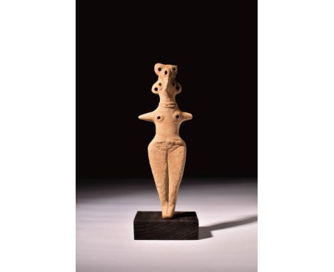 Ca. 1700 - 1200 BC.A pottery figure in buff colour depicting Astarte. The figure has bird-like facial features, with big roun
