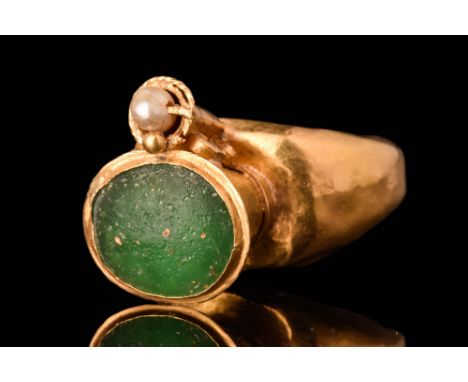 Ca. AD 500 - 600.A beautiful electrum ring, featuring a circular hoop, and a finely decorated trumpet bezel. The bezel is set