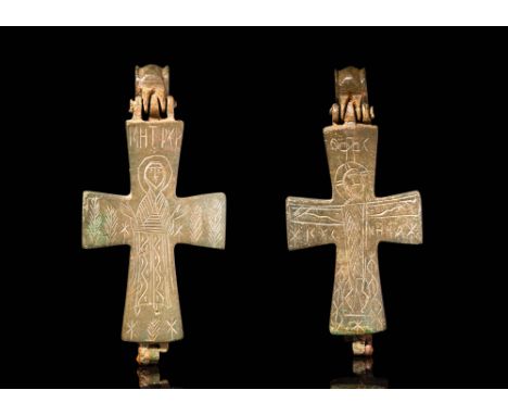 Ca. AD 900 - 1200.A Byzantine bronze enclopion composed by two valves. On the front side we see a veiled figure, wrapped in a