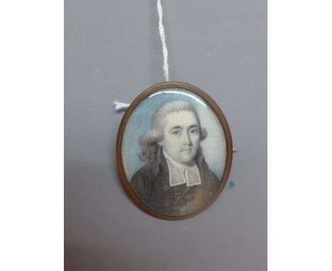 19th Century British School, a miniature portrait of a gentleman, painted on ivory, mounted on as brooch, possibly rose gold 