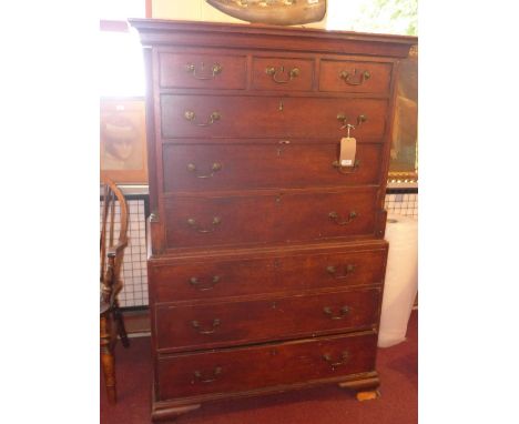 A 19th Century oak tall boy with an arrangement of nine drawers, reeded column and raised on carved bracket feet, H:164cm W:1