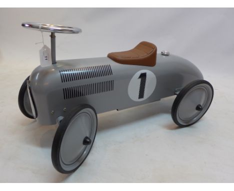 A Schylling toys childs ride on in the form of a FI Vintage racing car in silver