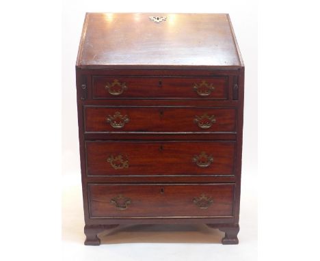 A 19th Century mahogany bureau with drop down flap above four graduating drawers raised on carved bracket feet, H:94cm W:61cm