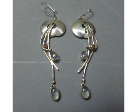 A pair of silver, ruby and moonstone set drop earrings in the Art Nouveau style