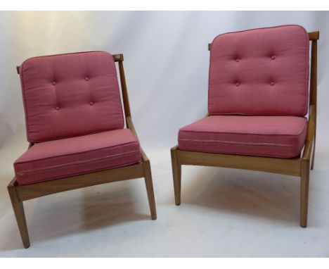 A pair of Greaves and Thomas teak stick back chairs, raised on tapered legs.  