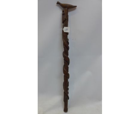 A 19th Century wooden folk art walking stick carved with a snake leading up to a duck handle. 