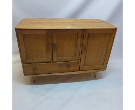 An Ercol elm sideboard with three cupboard doors and one single drawer raised on splayed legs, H:81cm W:114cm D:51cm