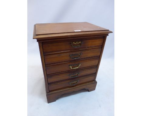 A late 19th Century oak music cabinet with five drawers raised on carved bracket feet, H:58cm W:48cm D:34cm