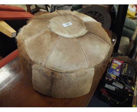 AN UNUSUAL SKIN POUFFE