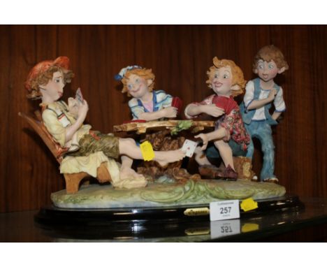 A PEGASUS FIGURE OF CHILDREN PLAYING CARDS