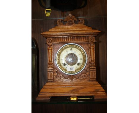A CARVED OAK ANSONIA AMERICAN MANTEL CLOCK