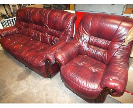 A RED THREE SEATER SOFA TOGETHER WITH MATCHING ARMCHAIR
