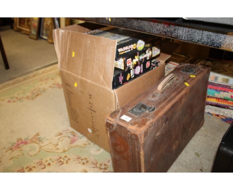 A VINTAGE LEATHER SUITCASE TOGETHER WITH A BOX OF MODERN JIGSAWS
