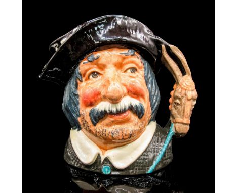 Glazed, hand painted ceramic. Sancho Panca is in a black hat with a white feather, and black coat with a white collar. The ha