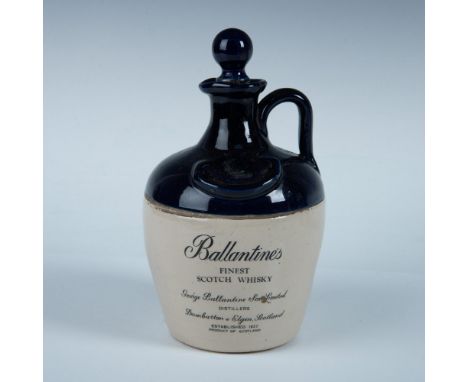Empty ceramic whisky bottle finished with cobalt blue glaze on top half and clear glazed bottom half. Dimensions: 8.5"H x 5" 
