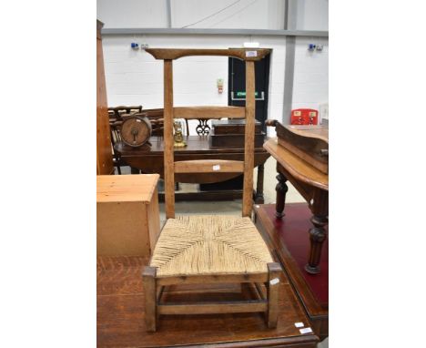 A 19th Century low seat ladder back chair having strung seat