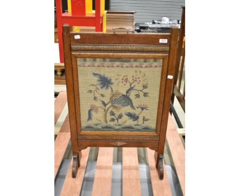 An early 20th Century oak tapestry fire screen