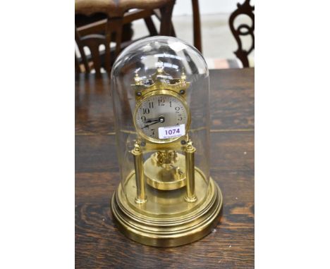A brass anniversary clock#, signed Gustav Becker having glass dome top