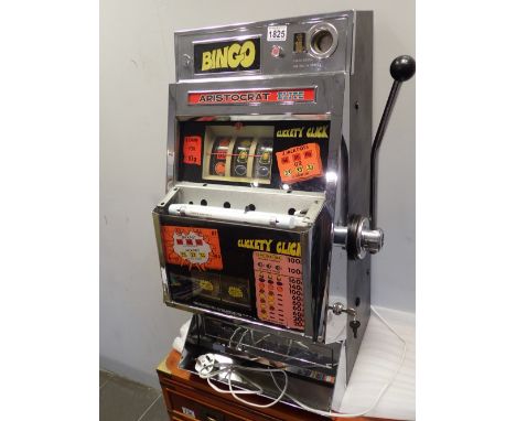 Original 1970s one arm bandit Aristocrat Elite CONDITION REPORT: With key in working order.
Glass shelf above doors is absent