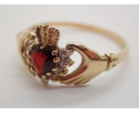 9ct gold ring with ruby and diamond stones in hands