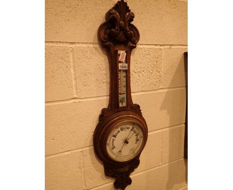 Antique aneroid barometer with thermometer in heavily carved mount